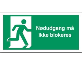 Grønt flugtvejsskilt med hvidt løbende mand-symbol og teksten 'Nødudgang må ikke blokeres' i hvid skrift.