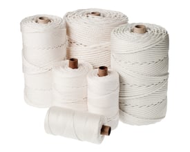 Hvide nylon flisesnore i forskellige størrelser på spoler, samlet på en hvid baggrund.