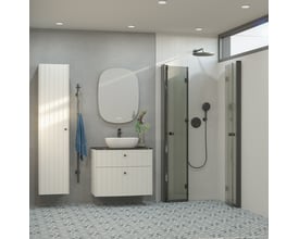 Dansani Pixel greb i sort, 26 mm diameter, vist monteret på et hvidt skab i et moderne badeværelsesmiljø.