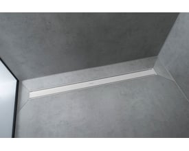 Hansgrohe 800 mm afløbsrende i mat hvid finish integreret i et moderne badeværelsesgulv med betonlook.