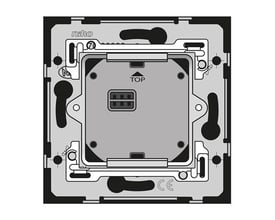 Bagside af Niko Home Control indsats til bevægelsessensor, viser monteringsmekanismer og tilslutningsport i grå nuancer.