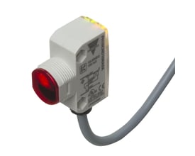 Carlo Gavazzi fotoaftaster PH18CNB20PASA med kvadratisk M18-hus, rød frontlinse og gråt kabel.