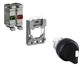 Tre dele af en ABB drejeomskifter: et kontaktmodul med grønne og røde trykknapper, en monteringsramme og selve drejeknappen.