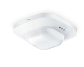 Steinel tilstedeværelsessensor IR Quattro HD COM2 i hvid plast til indendørs loftmontering, med synlige indikatorlamper og Steinel logo.