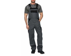 Kansas Icon arbejds-overall i grå/sort, model 100812, vist på en mand med en grå t-shirt, der fremviser lommer og reflekser.