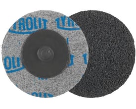 Tyrolit Qdisc presset 51XR 2 C fine P til afgratning og rengøring, vist med monteringsknap og groft slibeunderlag.