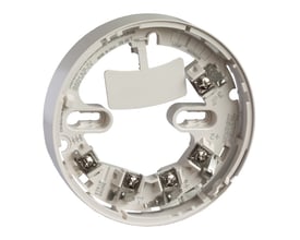 Schneider Electric standard sokkel beige B501 AP-IV, en hvid cirkulær base med metalterminaler og mærket 'System Sensor'.