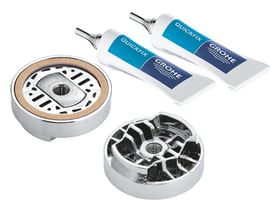 Grohe QuickGlue Set S2 med to tuber QuickFix lim, en monteringsbase og en kromdetalje på hvid baggrund.