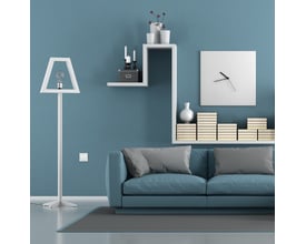 Lauritz Knudsen Friends Of Hue trådløst tryk i hvid, monteret på en blå væg ved siden af en lampe og sofa.