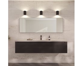 Loevschall Refine spejl med en slank, bruneret messingramme, 55x160 cm, monteret over et mørkt væghængt badeværelsesskab.