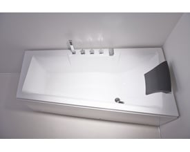 Top view af Riga badekar i hvid sanitetsakryl med moderne armatur og et asymmetrisk, mørkegråt nakkestøtte.