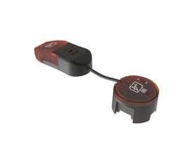 Ansell Lighting Prism Pro XM erstatningsdriver med sorte huse, røde gennemsigtige toppe og forbindelseskabel, set skråt fra oven.
