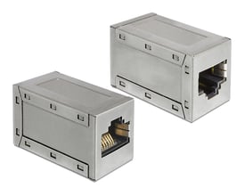 Sølvfarvet DeLOCK RJ45-modulkobling, skærmet Cat 6A, vist fra to vinkler med åbninger til stik i begge ender.