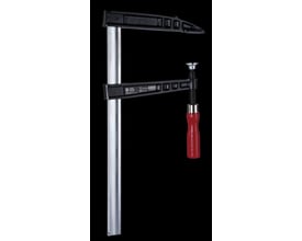 Kukko skruetvinge 600/250mm lavet af sort støbejern med en skinnende metal skinne og et rødt træhåndtag mod en sort baggrund.