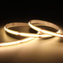 Ansell Lighting C-Cell COB LED strip på 50 meter, 24V, med varmt hvidt 3000K lys og 8W/meter, vist bøjet på en mørk baggrund.