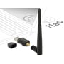 DeLOCK trådløst USB-netværkskort med løs antenne og beskyttelseshætte ved siden af, vist foran en computer.