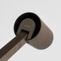 Astro Lighting Ascoli Floor gulvlampe set tæt på, med Astro-logo og cylindrisk lampehoved i bronze.