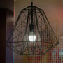 V-TAC 20W LED pære installeret i en dekorativ geometrisk pendel, som giver et varmt lys.
