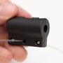 Nærbillede af en Deltaco HDMI adapterrings monteringsbeslag med skruer og wire, holdt i hånden.