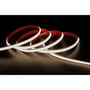 En LEDlife vandtæt slim COB LED strip rullet sammen på en mørk baggrund, hvor den røde bagside med tape er synlig.