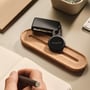 Chipolo LOOP Bluetooth-tracker hænger ved en bilnøgle og ligger på en korkbakke, set forfra med den runde front synlig.