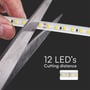 Nærbillede af V-TAC LED stribe, der viser en person klippe den, med information om 12 LED's per klippestøkke.