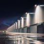 Industribygning oplyst af en lang række V-TAC 300W LED projektører langs facaden i mørket.