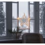 Konstsmide vindues-silhuet stjerne med 35 varmhvide LED, hængende i et vindue med sne udenfor.