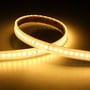 Ansell Lighting U-Cell LED strip 30m, 48V, IP67, med 240 LED/m og 4000K neutral hvidt lys, draperet på mørk baggrund.