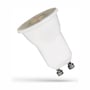 SpectrumLED mini GU10 LED-pære på 2 W set skråt fra siden; linsen vender op mod venstre, og de to metalben ses nederst.