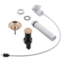 Grohe afløbssæt med 1 1/4" tilslutning i børstet Warm Sunset, viser bundventil med push-open, strainer og afløbsrør.