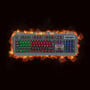 Deltaco DK130 gamingtastatur set ovenfra med regnbuebelysning mod en grafisk baggrund af flammer.
